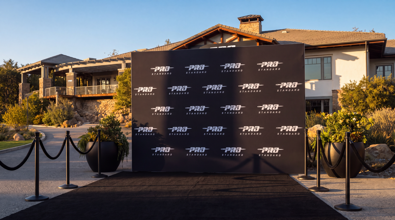 Black step-and-repeat backdrop with Pro Standard logos and black carpet