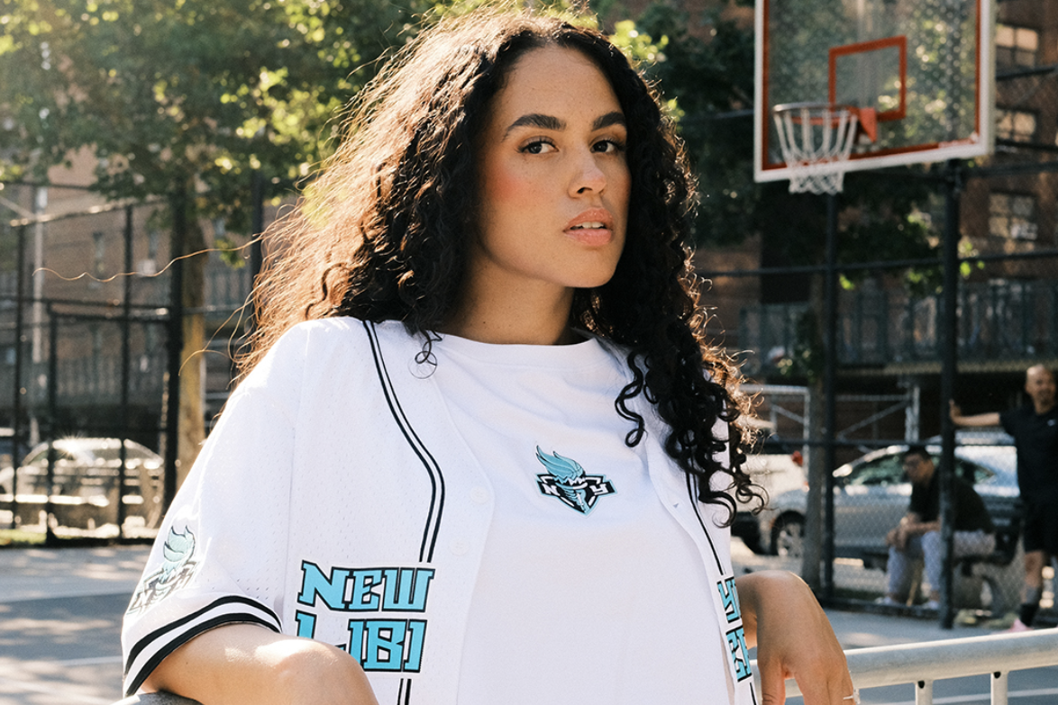 Woman wearing Pro Standard apparel on a community basketball court