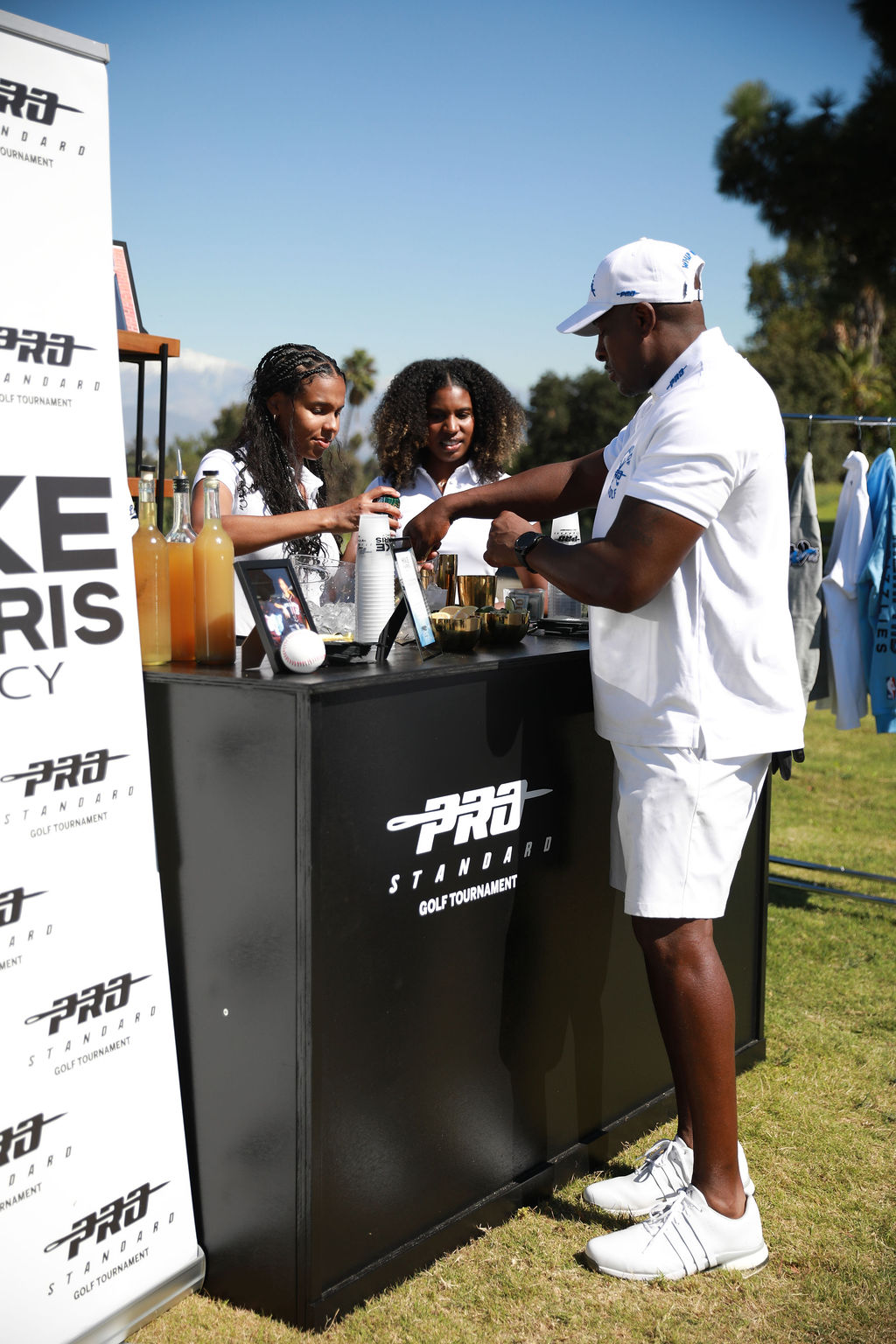 Bartenders pouring cocktails at the on-course bar activation