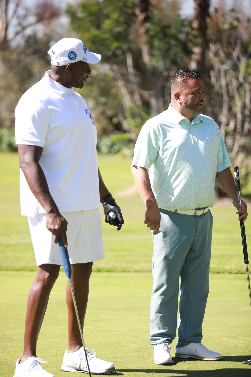 Two players reading a putt on the green