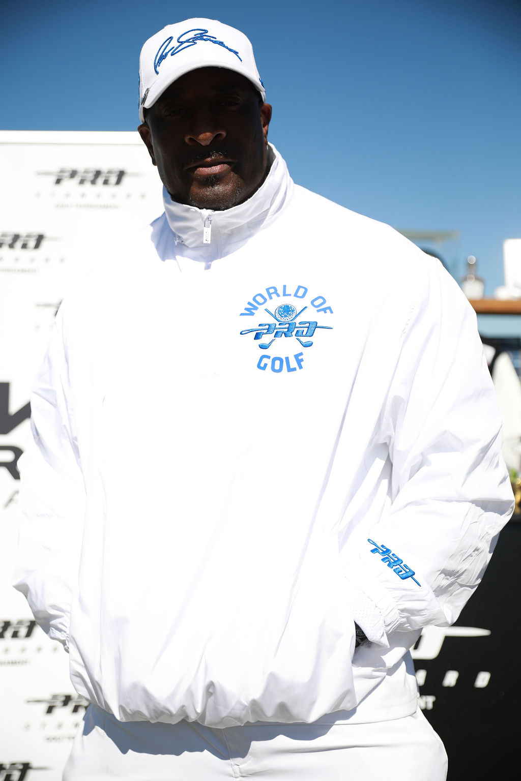 Player in the white World of Golf pullover